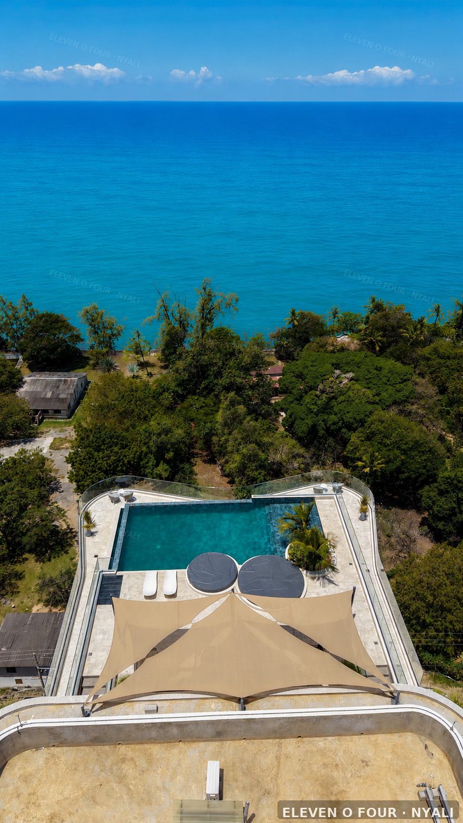 Aerial view of Evoque's rooftop pool and the Indian Ocean