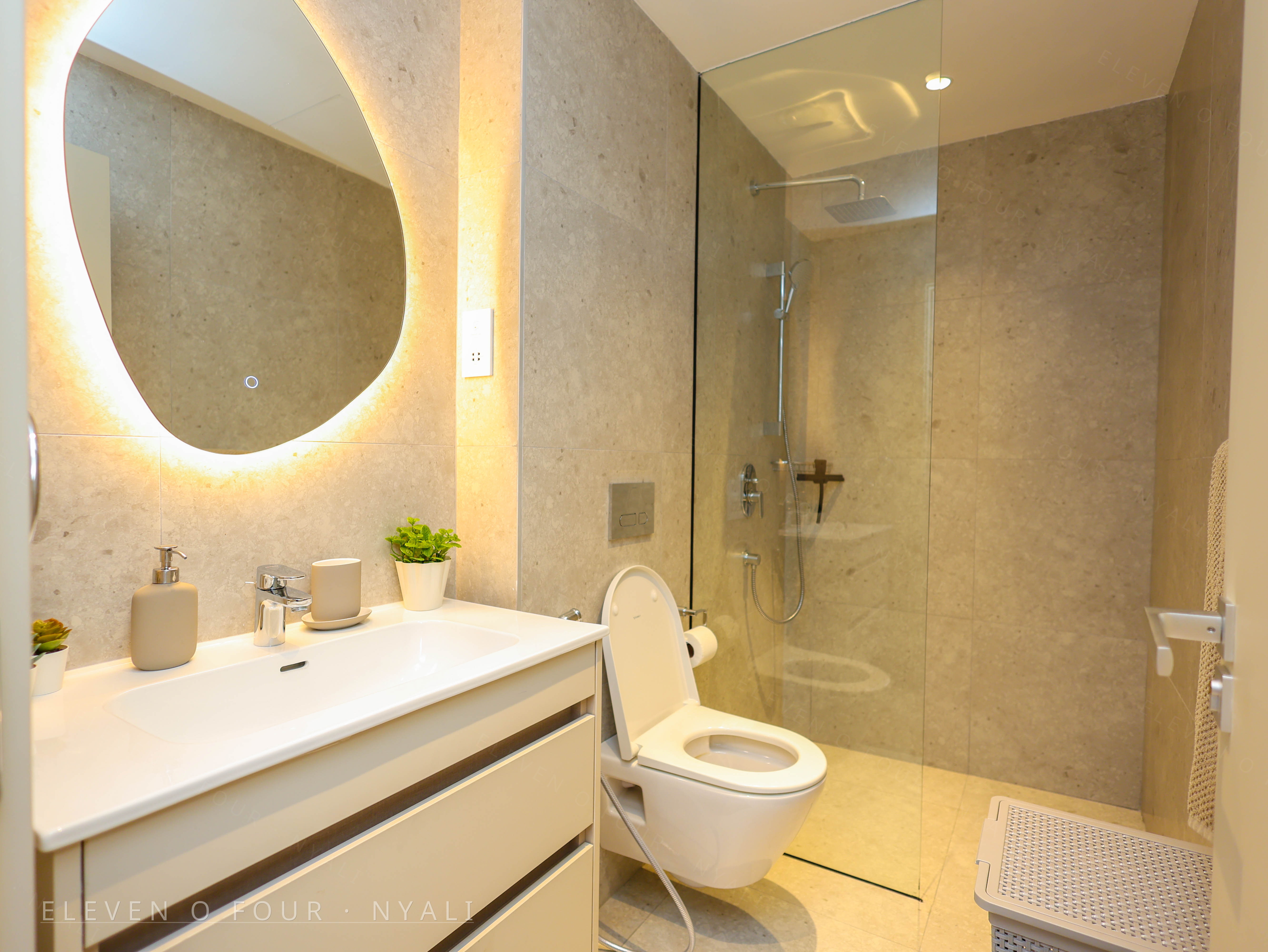 Modern bathroom with illuminated mirror and rain shower